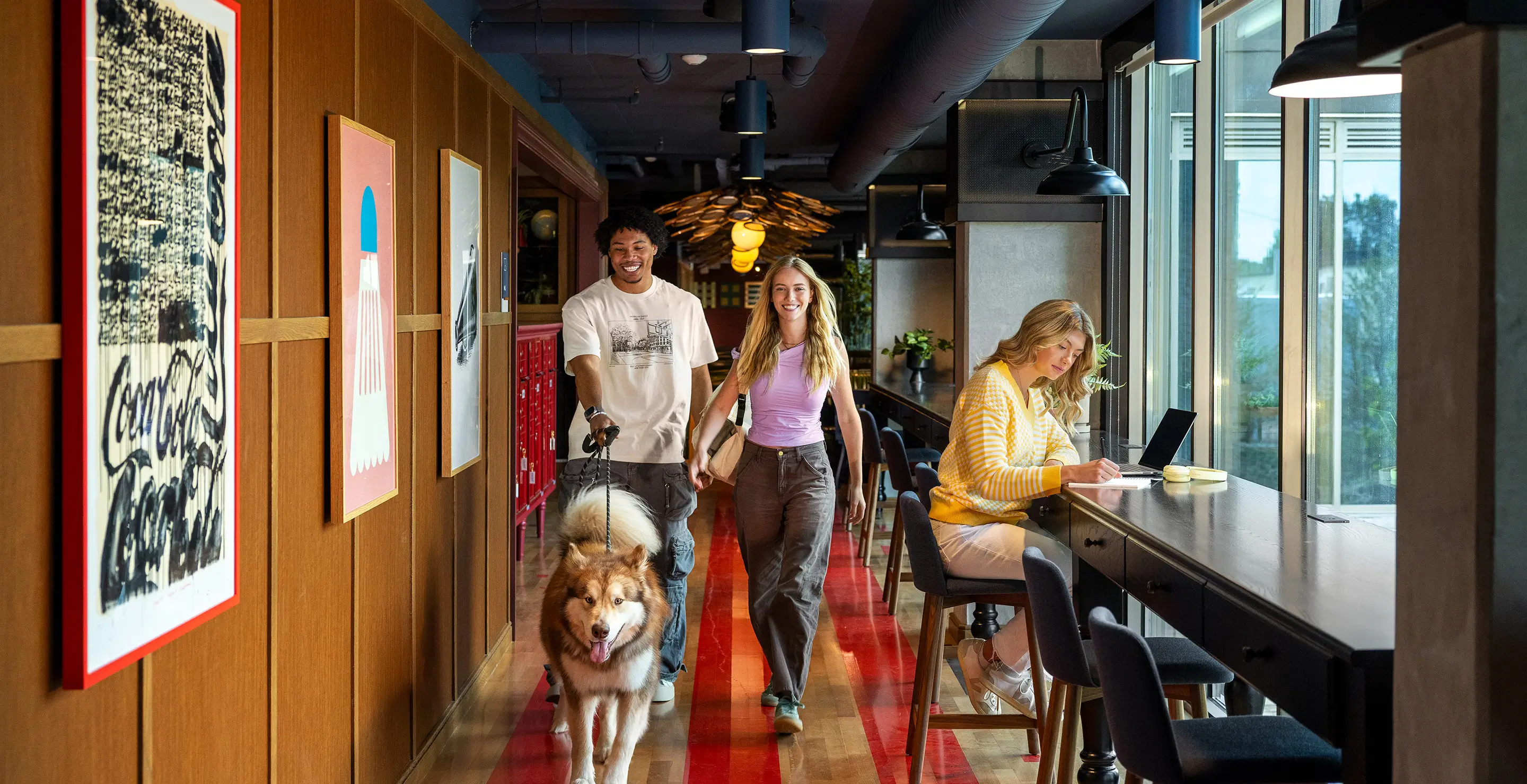 young adults walking a dog