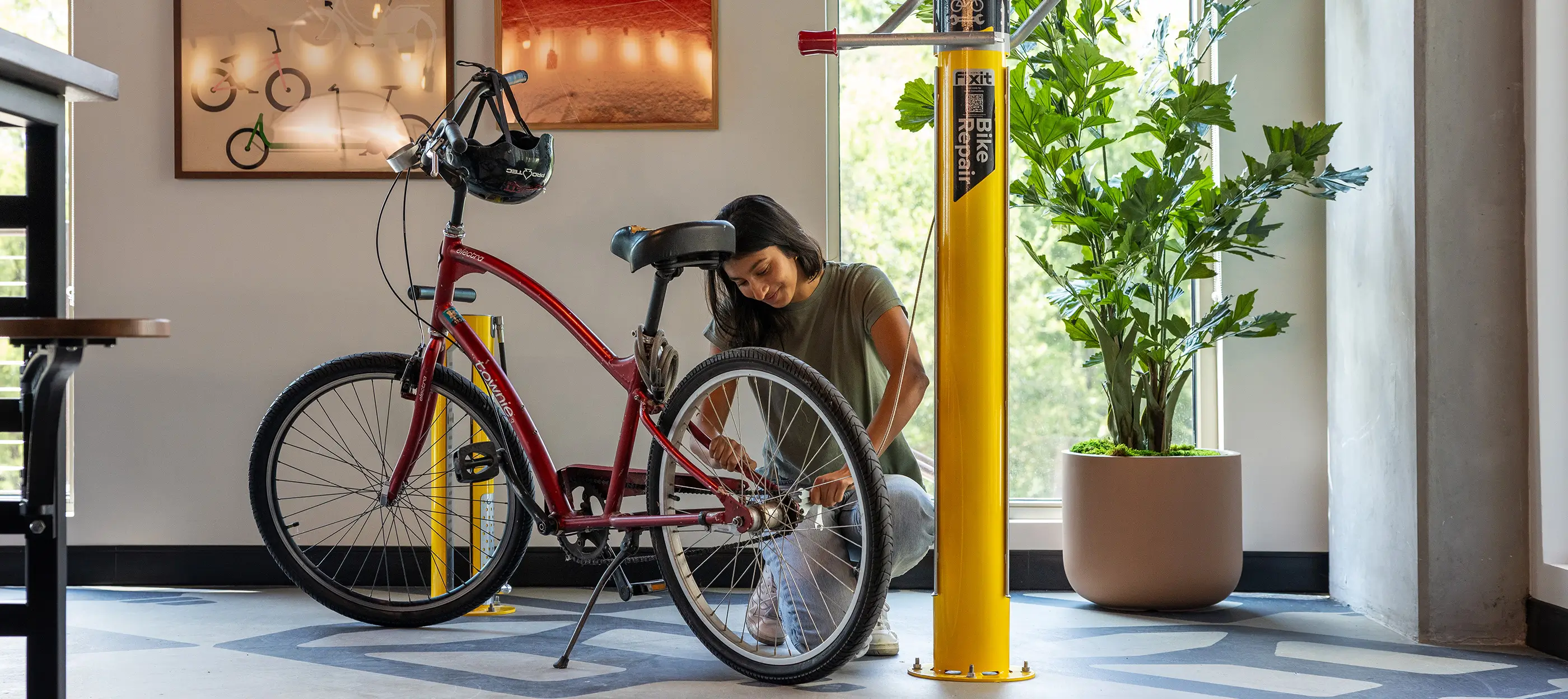 young woman fixing a bike